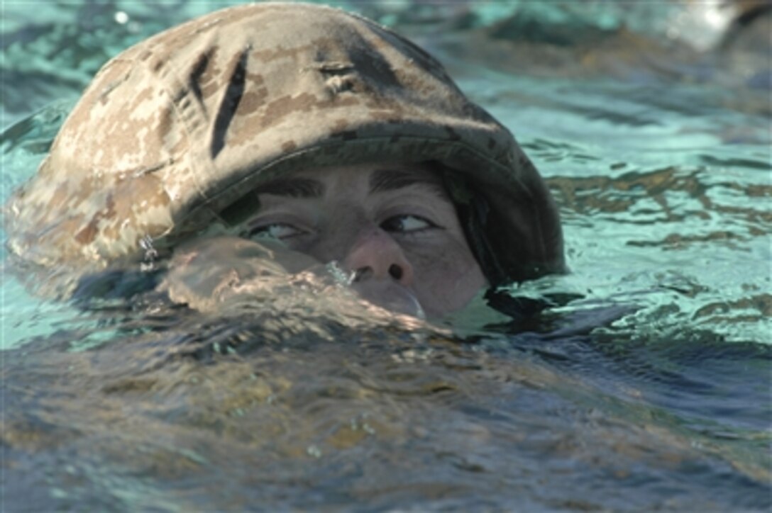 A U.S. Marine from Golf Company, 2nd Battalion, 1st Marine Regiment, swims across a training tank pool during annual swim qualifications at Camp Pendleton, Calif., on Nov. 29, 2006.  The swim qualification is designed for Marines to maintain amphibious operation readiness.  