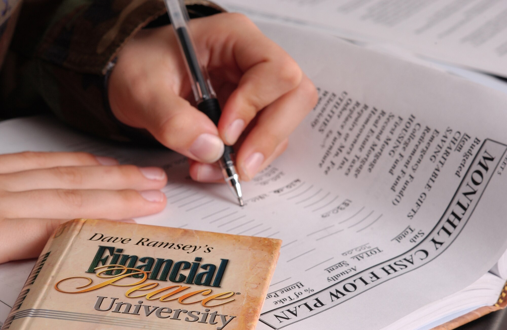 A student fills in a monthly cash flow worksheet while attending Dave Ramsey's Financial Peace University class hosted by the Little Rock Air Force Base chapel. The program is currently offered quarterly and is designed to teach Airmen and their families how to manage their finances.
Photo by Staff Sgt. Jonathan Pomeroy