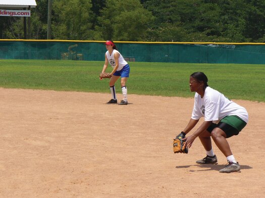 LACKLAND AIR FORCE BASE, Fla. --  Tricia Bell, front, first baseman and Jessica Joepp, second baseman, get ready to catch an incoming ball. The Tyndall softball team is part of the Panama City Softball League and regularly play games at the Oakland Terrace Softball Complex during the season. (Photo by Daryl Shines)