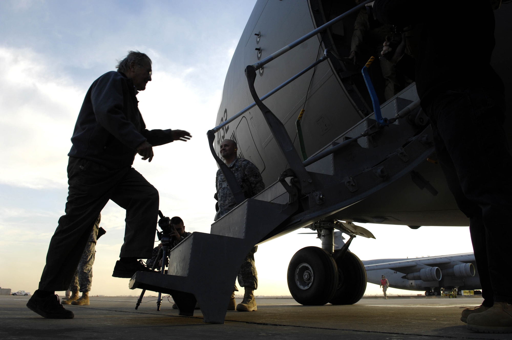 Secretary of Defense Donald H. Rumsfeld boards a U.S. Air Force C-17 Globemaster III aircraft after a surprise visit with servicemembers  Dec. 9 at Balad Air Base, Iraq. (Department of Defense photo/Cherie A. Thurlby)