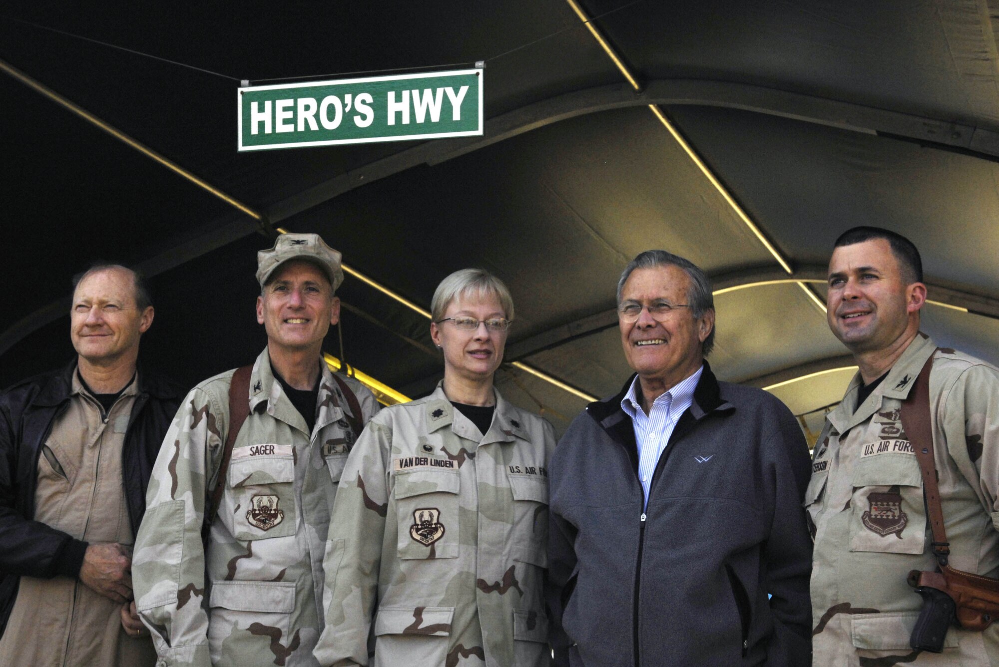 Secretary of Defense Donald H. Rumsfeld takes a photo Dec. 9 with medical staff members from the Air Force Theatre Hospital at Balad Air Base, Iraq. Rumsfeld made a surprise visit to Iraq to thank servicemenbers and their families for their sacrifices and service to the country. (Deparment of Defense photo/Cherie A. Thurlby)