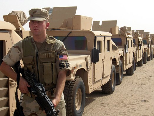 Senior Airman Matthew R. Myhra, 30th Security Forces Squadron, patrols a convoy at Ali Al Saleem Air Base, Kuwait.  Airman Myhra aided in the rescue of a Kuwaiti pilot after his aircraft crashed near the base.  Airman Myhra sustained burns during the rescue and was released back to work the next day.  (Courtesy Photo)