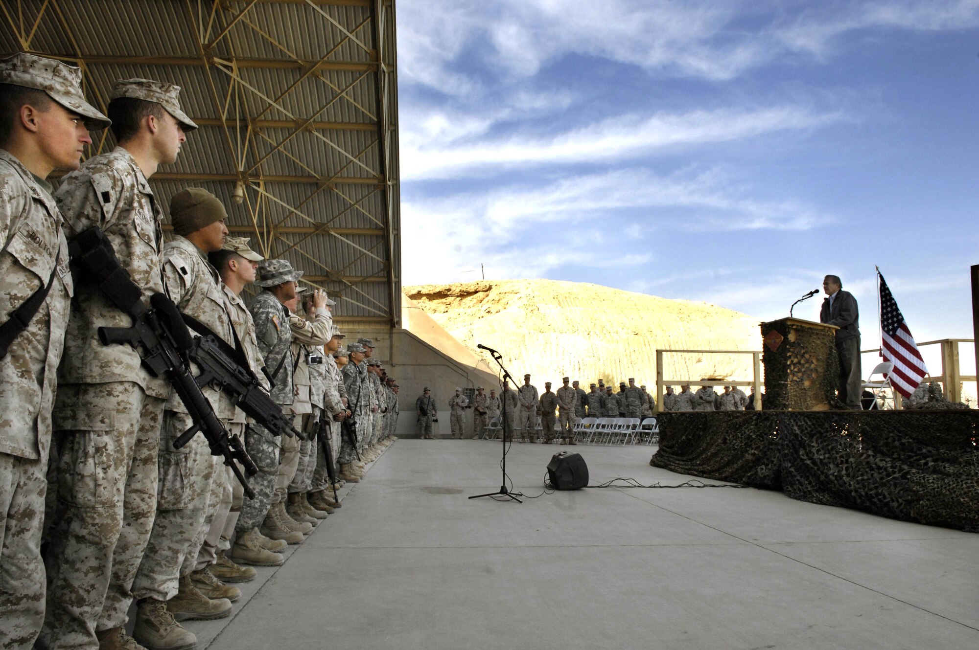 Secretary of Defense Donald H. Rumsfeld addresses servicemembers at a town hall meeting Dec. 9 on Al Asad Air Base, Iraq. Rumsfeld made a surprise visit to Iraq to thank the military and their families for their sacrifices and service to the country. (Deparment of Defense photo/Cherie A. Thurlby.)