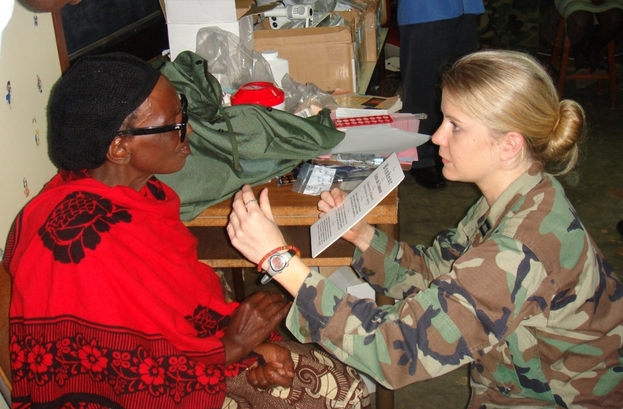 Capt. Christie Barton, an optometrist from Ramstein’s 435th Medical Group, exams a local Rwandan woman during a medical capabilities mission that five medics from around the command participated in recently.  The group from Aviano and Ramstein performed eye and dental exams for nearly 1,000 refugees, and in conjunction with Rwandan Military Defense Force and the International Red Cross, they held medical seminars for approximately 50 local doctors as part of the two-week military-to-military operation.  