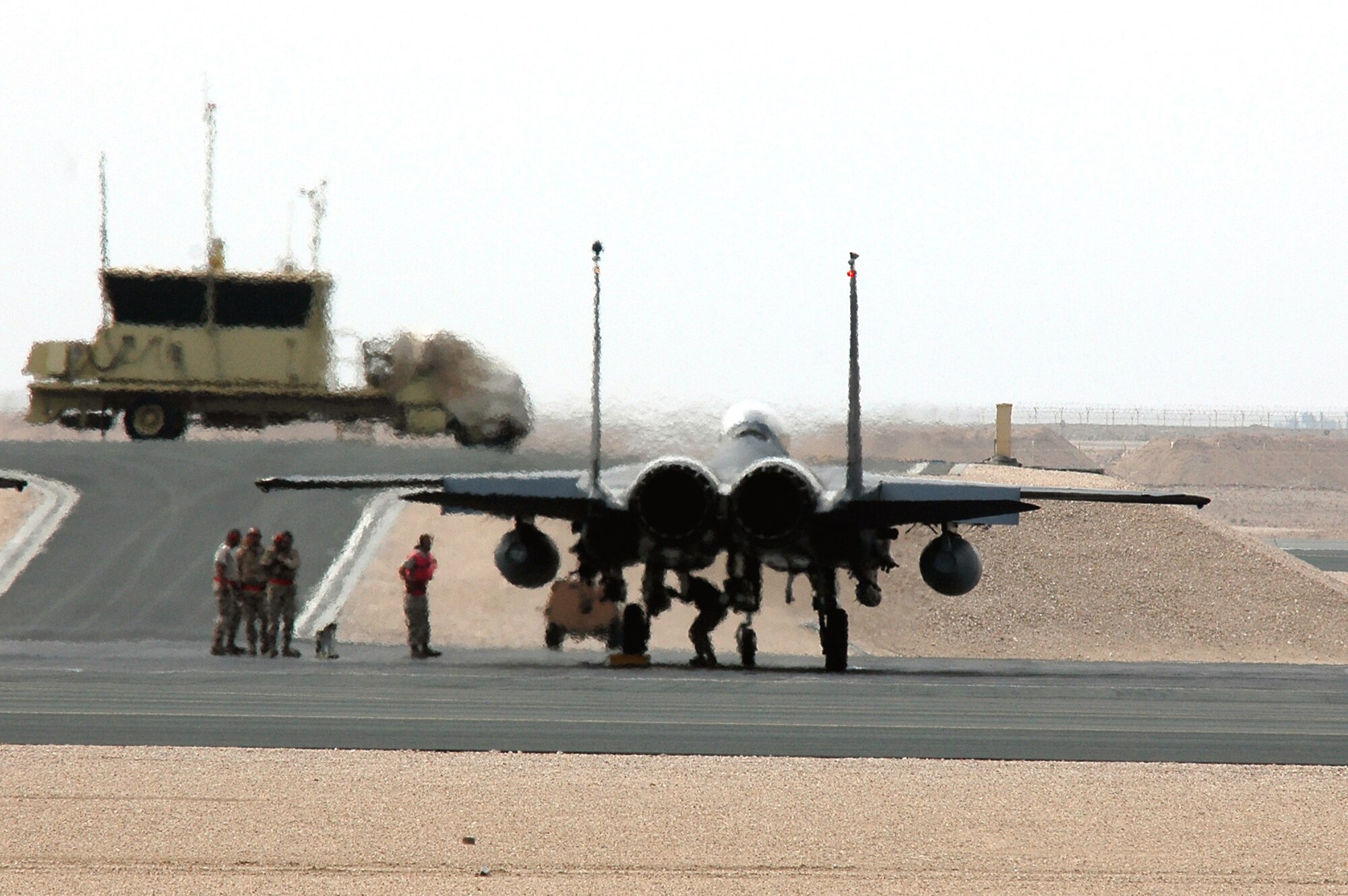 An F-15 Strike Eagle sits at the end of a runway in Southwest Asia for last-minute safety and armament checks Dec. 11. The F-15s are deployed to the 494th Expeditionary Fighter Squadron in support of Operation Iraqi Freedom. The 494th EFS was the first unit to fly the guided bomb unit 39/B small diameter bomb into combat in October. The new bomb, the first of its kind in the Air Force inventory, gives aircrews the ability to destroy targets that would normally be passed over due to the proximity of friendly troops, civilians, structures or personal property. (U.S. Air Force photo/Master Sgt. Shaun Withers)
