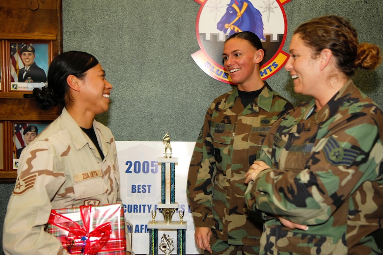 Hanscom AFB -- From left, Staff Sgt. Dianne Zulueta, 66th Security Forces Squadron, is greeted by Staff Sergeants Susan Ellis and Amy Hickey, 66 SFS, following Sergeant Zulueta's return to Hanscom Air Force Base Monday. Sergeant Zulueta returned with a group of 17 other Hanscom personnel following a deployment in support of the Global War on Terror. (U.S. Air Force Photo by Jan Abate)