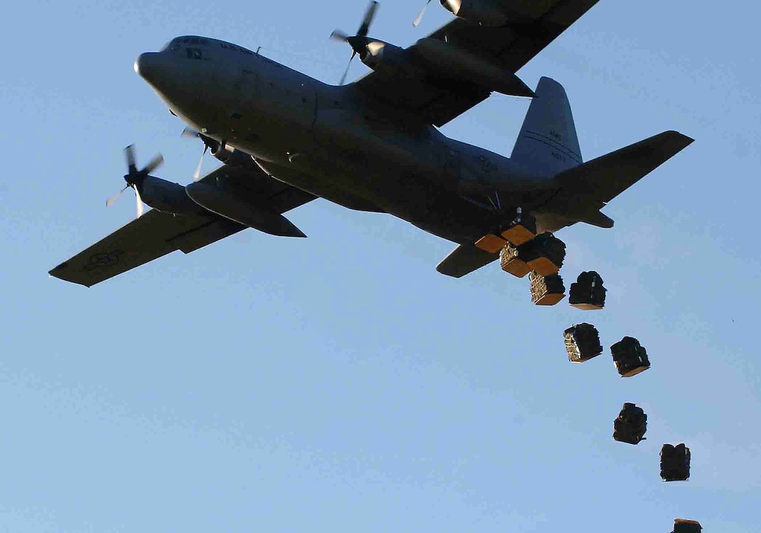 A U.S. Air Force C-130 Hercules aircraft drops bundles of shelters and mosquito nets onto a field in Dadaab, Kenya, Dec. 10, 2006.  The materials are being dropped by U.S. servicemembers assigned to Combined Joint Task Force - Horn of Africa as humanitarian aid for the approximately 160,000 stranded victims of recent flooding in rural areas of Kenya.