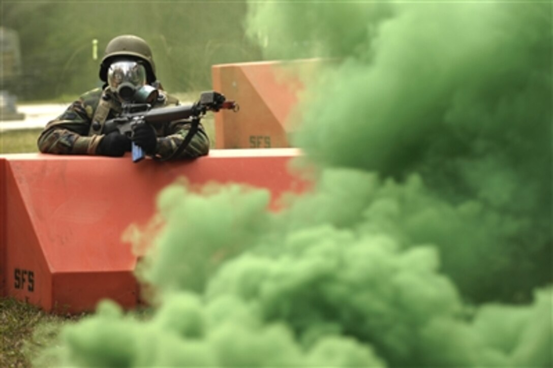 Airman 1st Class Lee Olson keeps watch during a simulated gas attack while participating in the Expeditionary Combat Skills Training at Charleston Air Force Base, S.C., Dec. 7. The   tactical operations course helps prepare Charleston airmen for future deployments. Olson is with the 437th Medical Group.