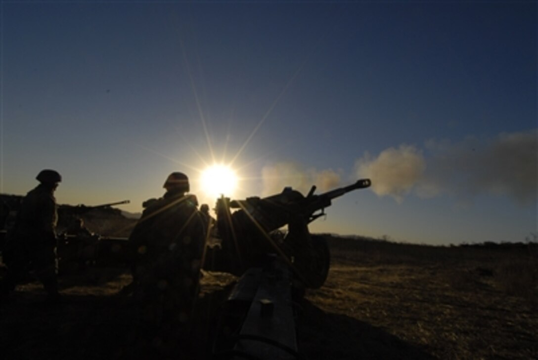 U.S. Marines from C Battery, 1st Battalion, 11th Marine Regiment fire an M198 Medium Towed Howitzer during a training exercise at Camp Pendleton, Calif., Dec. 2, 2006. 
