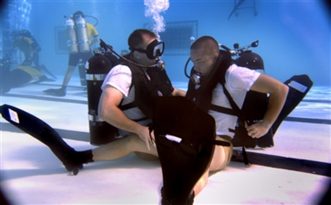 Scuba students at the Naval Diving and Salvage Training Center in Panama City, Fla., undergo confidence training in a 12-foot pool as part of a scuba certification course on Dec. 6, 2006.  Confidence training is a portion of a five-week course designed to test the students' reactions to real-world emergency situations.  