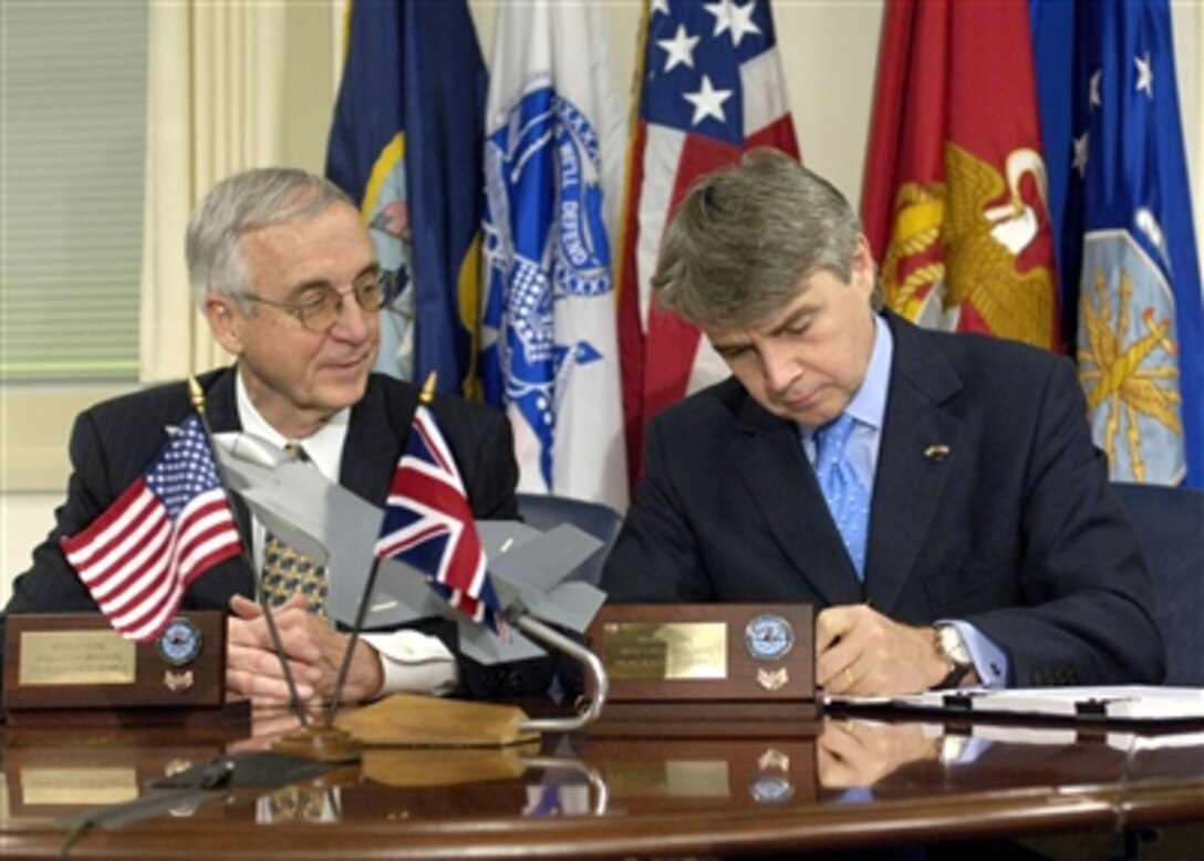 Deputy Secretary of Defense Gordon England (left) watches as the United Kingdom's Minister of Defence Procurement Lord Paul Rudd Drayson signs a memorandum concerning the Joint Strike Fighter program in the Pentagon on Dec. 12, 2006.  The document establishes a framework for cooperation in the production, sustainment and follow-on development of the aircraft.  The United Kingdom joins Canada, the Netherlands and the United States as the fourth nation to sign the memorandum.  