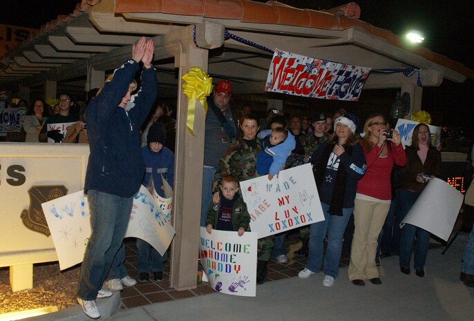 Families of Nellis Air Force Base, Nev., security forces Airmen wait at base operations for their loved ones to return from Camp Bucca, Iraq, Dec. 12. Seventy-two Airmen from the 99th Security Forces Squadron returned after eight months helping the Army. Three of the Airmen received Purple Hearts for combat injuries suffered in Iraq. (U.S. Air Force photo/Staff Sgt. Jeremy Smith)

