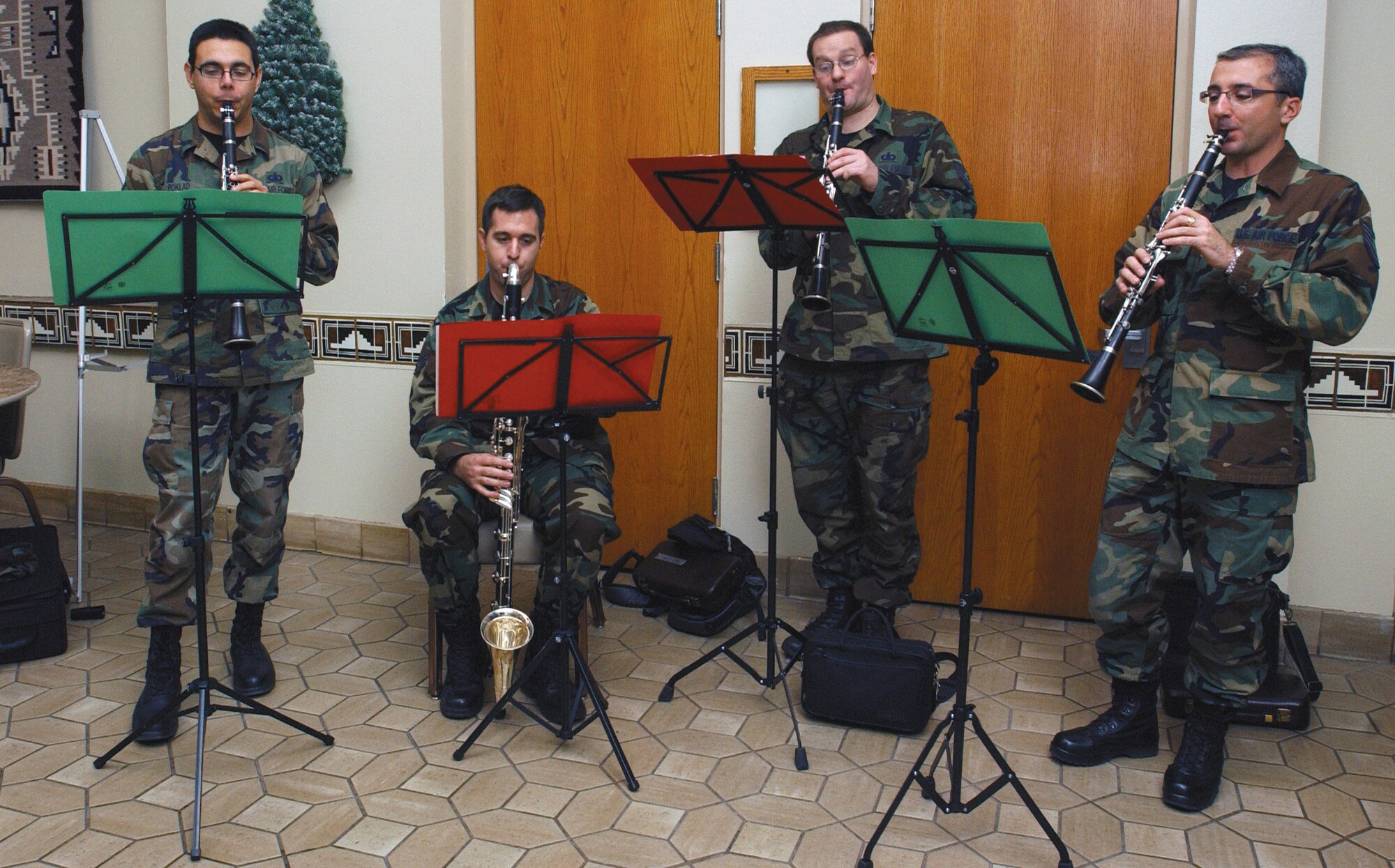 The clarinet quartet of the Air Force Band of the Golden West plays Christmas tunes at Nellis Air  Force Base, Nev., Dec. 12. From left are Staff Sgt. Igor Poklad, Senior Airman Greg Gallant, Technical Sgt. Kevin Conners, and Technical Sgt. Frank Milicia. The four musicians, stationed at Travis Air Force Base, Calif., spent the day spreading holiday cheer at the Mike O’Callaghan Federal Hospital, Base Exchange, Commissary, Lomie Heard Elementary School and several work centers. (U.S. Air Force photo/Staff Sgt. Jeremy Smith)