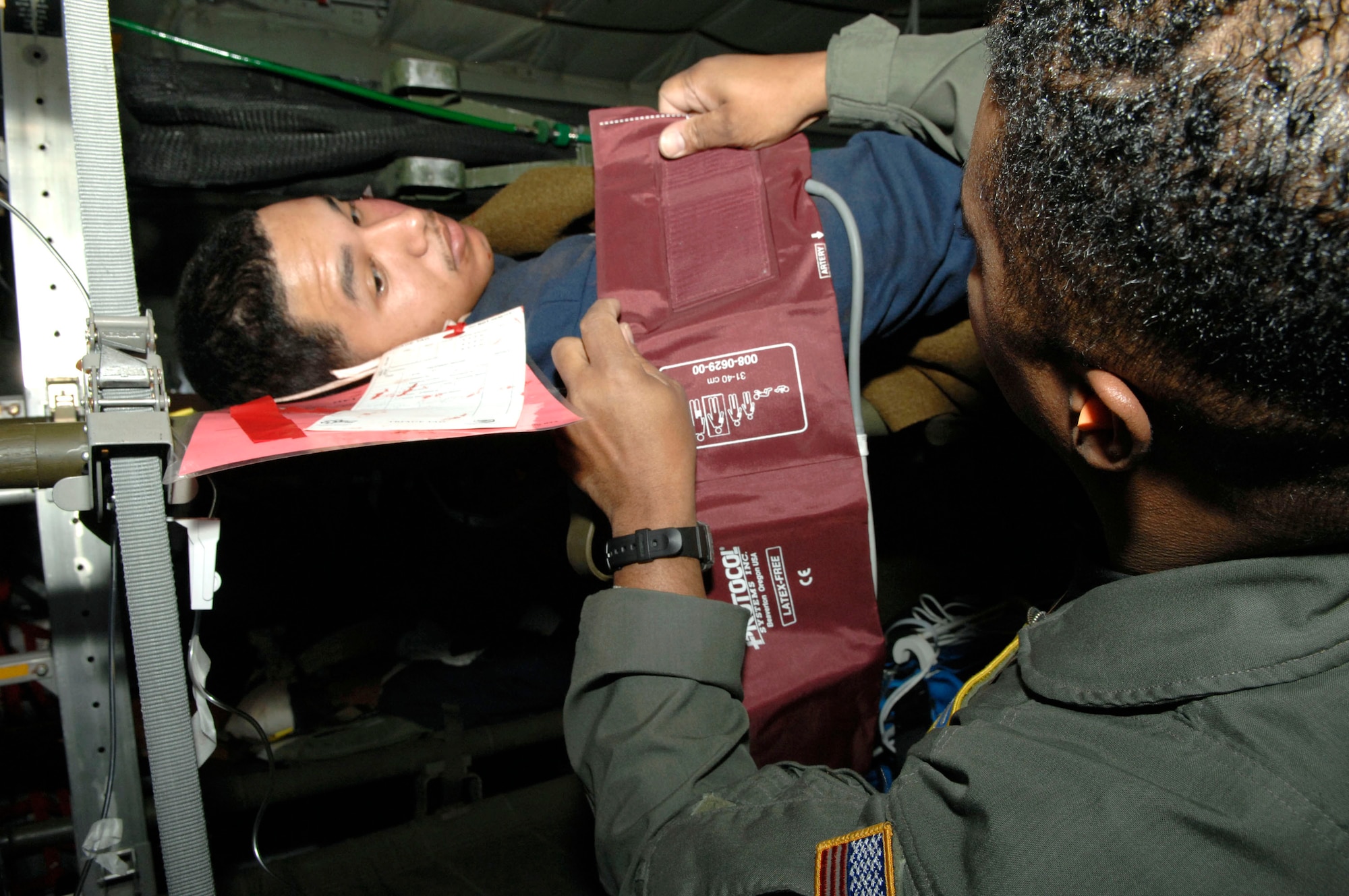 Airman 1st Class Justin Vargas, a "burn victim," has his blood pressure checked by a medical technician while being airlifted during the Collaborative Multi-Agency Medical Exercise, known as CMAX, that took place in the Washington D.C. area on Dec. 7.  The annual exercise was designed to test the capabilities of the local authorities to handle a major catastrophe. This was the first year that patient transport was included in the exercise.  Airman Vargas is with the 79th Medical Support Squadron, Bolling Air Force Base, D.C.  (U.S. Air Force photo/Tech. Sgt. Cohen Young)