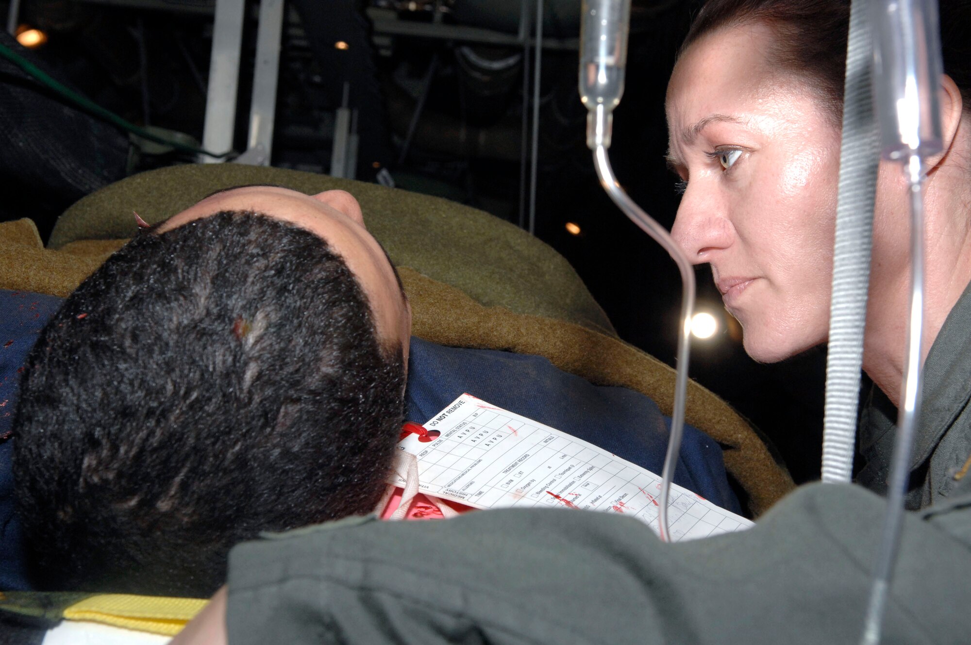 Lt. Dinah Lewis reassures Airman 1st Class Justin Vargas, a "burn victim" being airlifted during the Collaborative Multi-Agency Medical Exercise, known as CMAX, that took place in the Washington D.C. area on Dec. 7.  The annual exercise was designed to test the capabilities of the local authorities to handle a major catastrophe. This was the first year that patient transport was included in the exercise.  Lieutenant Lewis is a nurse from the Delaware Air National Guard and Airman Vargas is with the 79th Medical Support Squadron, Bolling Air Force Base, D.C.  (U.S. Air Force photo/Tech. Sgt. Cohen Young)