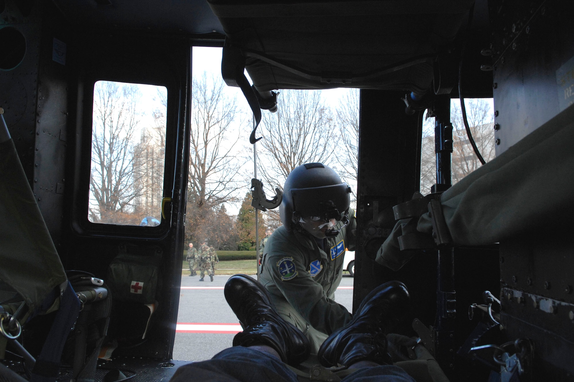 Staff Sgt. Ben Siems closes the door of a UN-1N Huey helicopter after Navy and Air Force medics loaded a "victim" onboard during the Collaborative Multi-Agency Medical Exercise, known as CMAX, that took place in the Washington D.C. area on Dec. 7.  The annual exercise was designed to test the capabilities of the local authorities to handle a major catastrophe. This was the first year that patient transport was included in the exercise.  (U.S. Air Force photo/Tech. Sgt. Cohen Young)