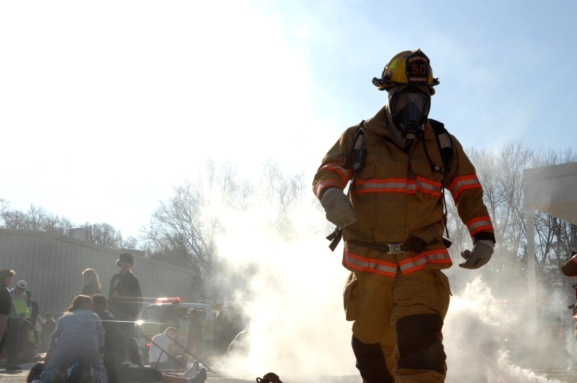 A fireman heads toward a "victim" after a simulated fuel explosion during the Collaborative Multi-Agency Medical Exercise, known as CMAX, that took place in the Washington D.C. area on Dec. 7.  The annual exercise was designed to test the capabilities of the local authorities to handle a major catastrophe. This was the first year that patient transport was included in the exercise.  (U.S. Air Force photo/Tech. Sgt. Cohen Young)