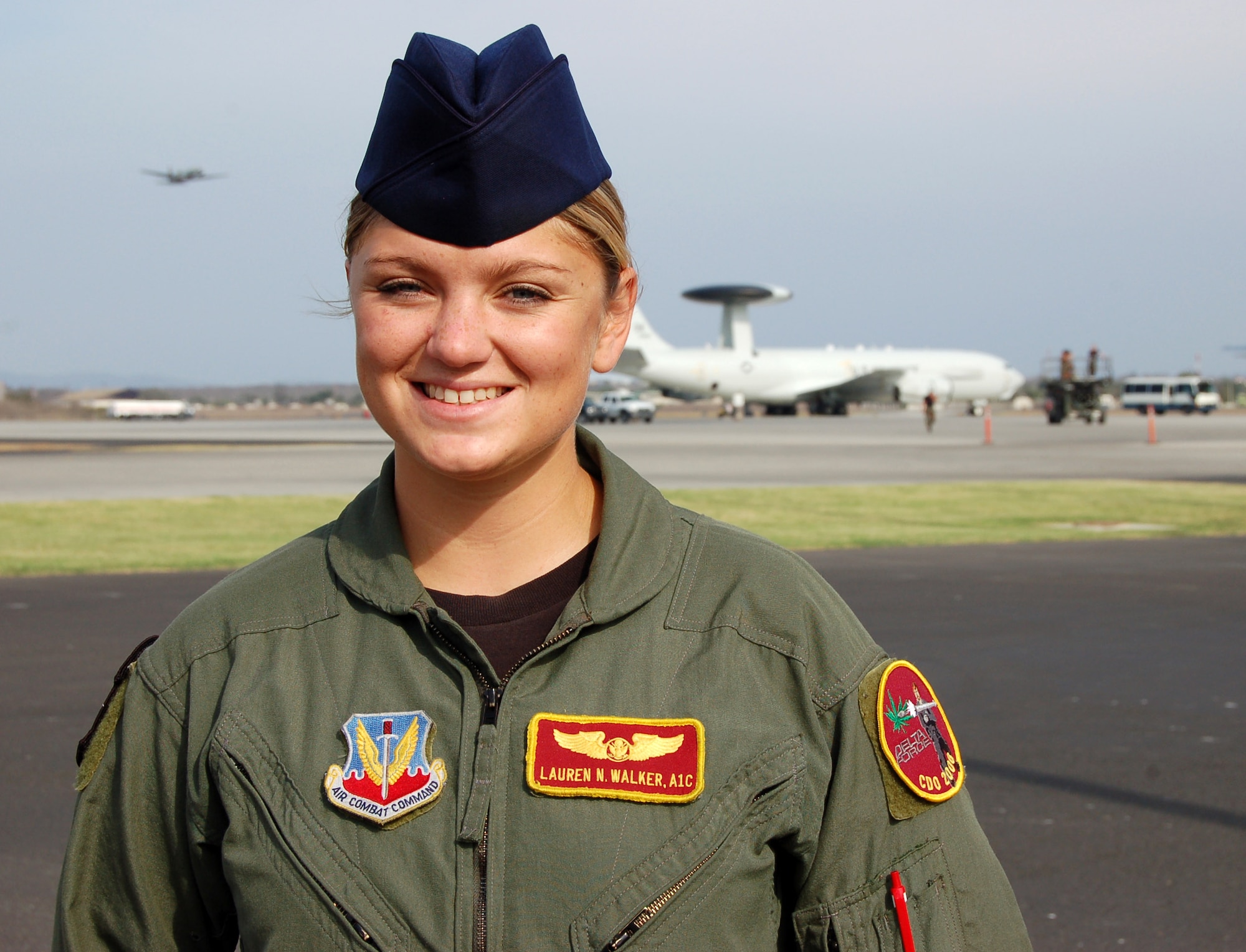 Airman 1st Class Lauren Walker is an airborne radar technician for the E-3 Sentry airborne warning and control aircraft (in background) at Manta Forward Operating Base in Ecuador. She and other Airmen at Manta met with Chief Master Sgt. of the Air Force Rodney J. McKinley during his visit to the joint inter-agency counterdrug mission hub. (U.S. Air Force photo/Louis Arana-Barradas)