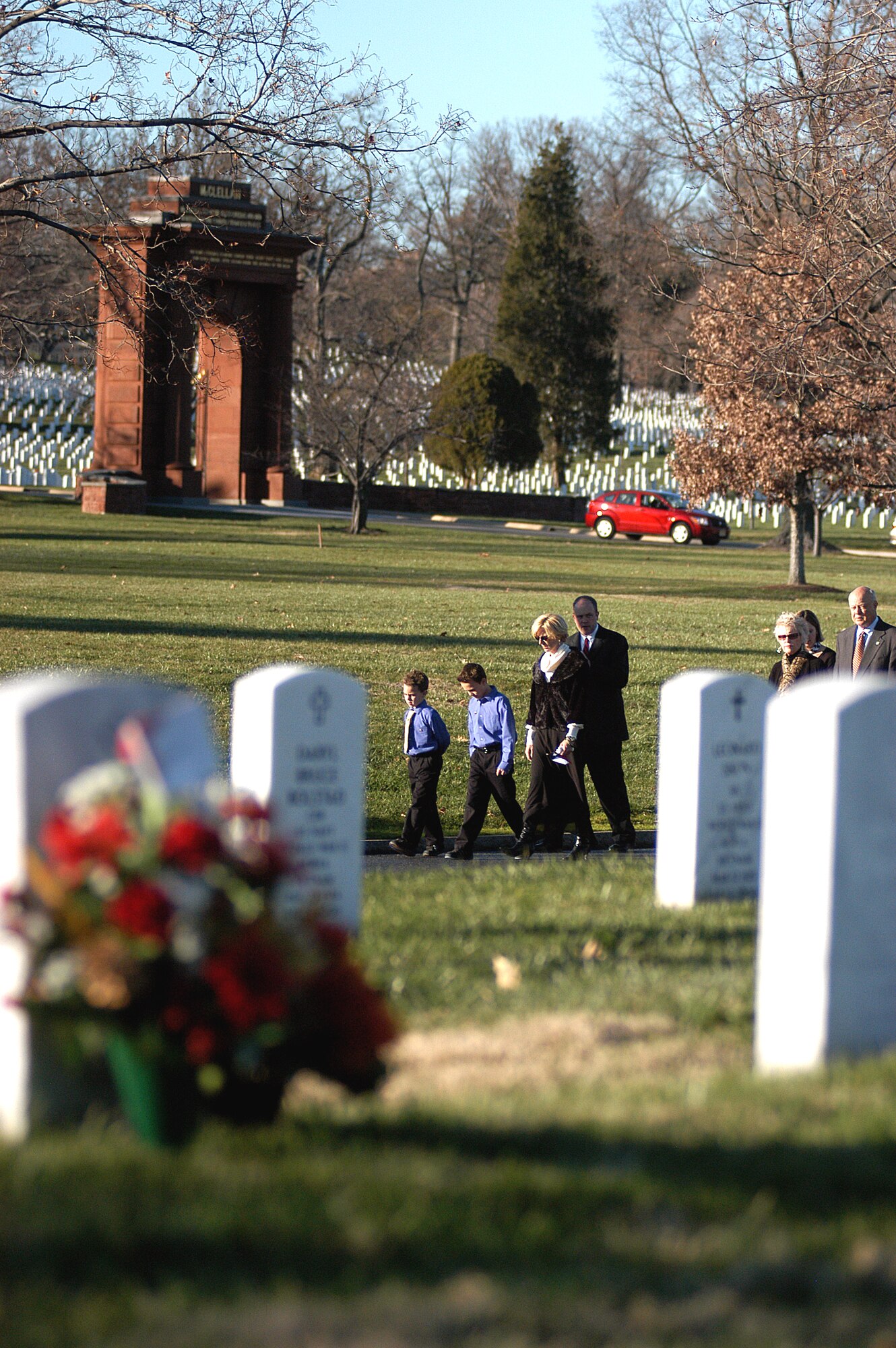 The family of Maj. Troy Gilbert walk to the grave site during a full honors funeral Dec. 11 at Arlington National Cemetery. Major Gilbert was the pilot of an Air Force F-16 Fighting Falcon engaged in support of coalition ground combat operations that crashed approximately 20 miles northwest of Baghdad Nov. 27. Major Gilbert was assigned to the 309th Fighter Squadron, Luke Air Force Base, Ariz., and was deployed to the 332nd Expeditionary Wing, Balad Air Base, Iraq. (U.S. Air Force photo/Maj. Francisco G. Hamm)