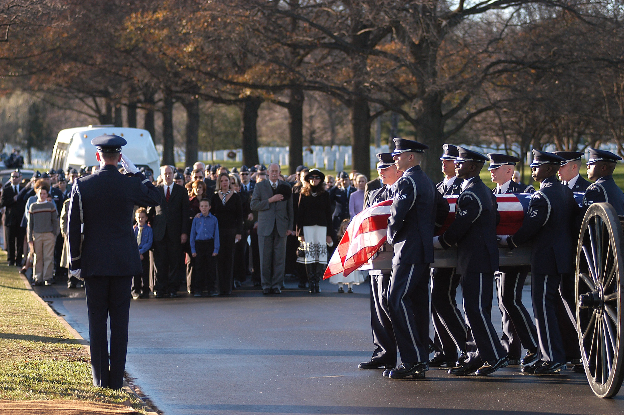 Air Force Honor Guardsmen transfer the casket carrying Maj. Troy Gilbert from the caisson to the grave site during a full honors funeral Dec. 11 at Arlington National Cemetery. Major Gilbert was the pilot of an Air Force F-16 Fighting Falcon engaged in support of coalition ground combat operations that crashed approximately 20 miles northwest of Baghdad Nov. 27. Major Gilbert was assigned to the 309th Fighter Squadron, Luke Air Force Base, Ariz., and was deployed to the 332nd Expeditionary Wing, Balad Air Base, Iraq. (U.S. Air Force photo/Maj. Francisco G. Hamm)