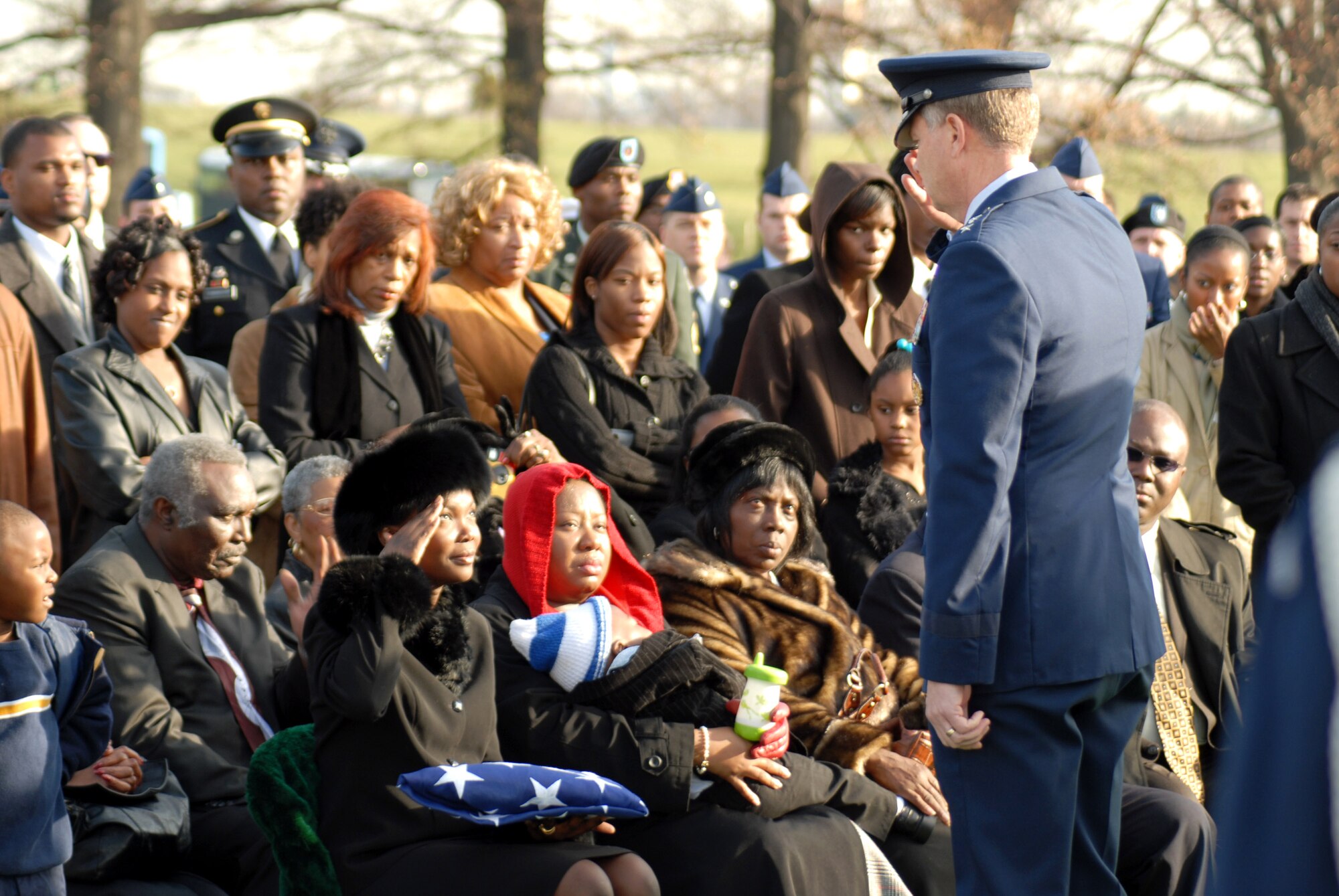 After the flag is handed to the next of kin, the final salute is rendered in honor of Capt. Kermit Evans and returned by Perneatha Evans, his wife, at a funeral Dec. 12 at Arlington National Cemetary. Captain Evans was killed in an emergency helicopter landing Dec. 3 near the shore of Lake Qadisiyah in Al Anbar Province, Iraq. Captain Evans was one of 16 people aboard the Marine CH-46 helicopter and one of four servicemembers killed as a result of the landing. He is survived by his wife and 13-month-old son, Kermit Jr. Captain Evans was the commander of the 27th Civil Engineer Squadron Explosives Ordnance Disposal Flight at Cannon Air Force Base, N.M. (U.S. Air Force photo/David Merrick)