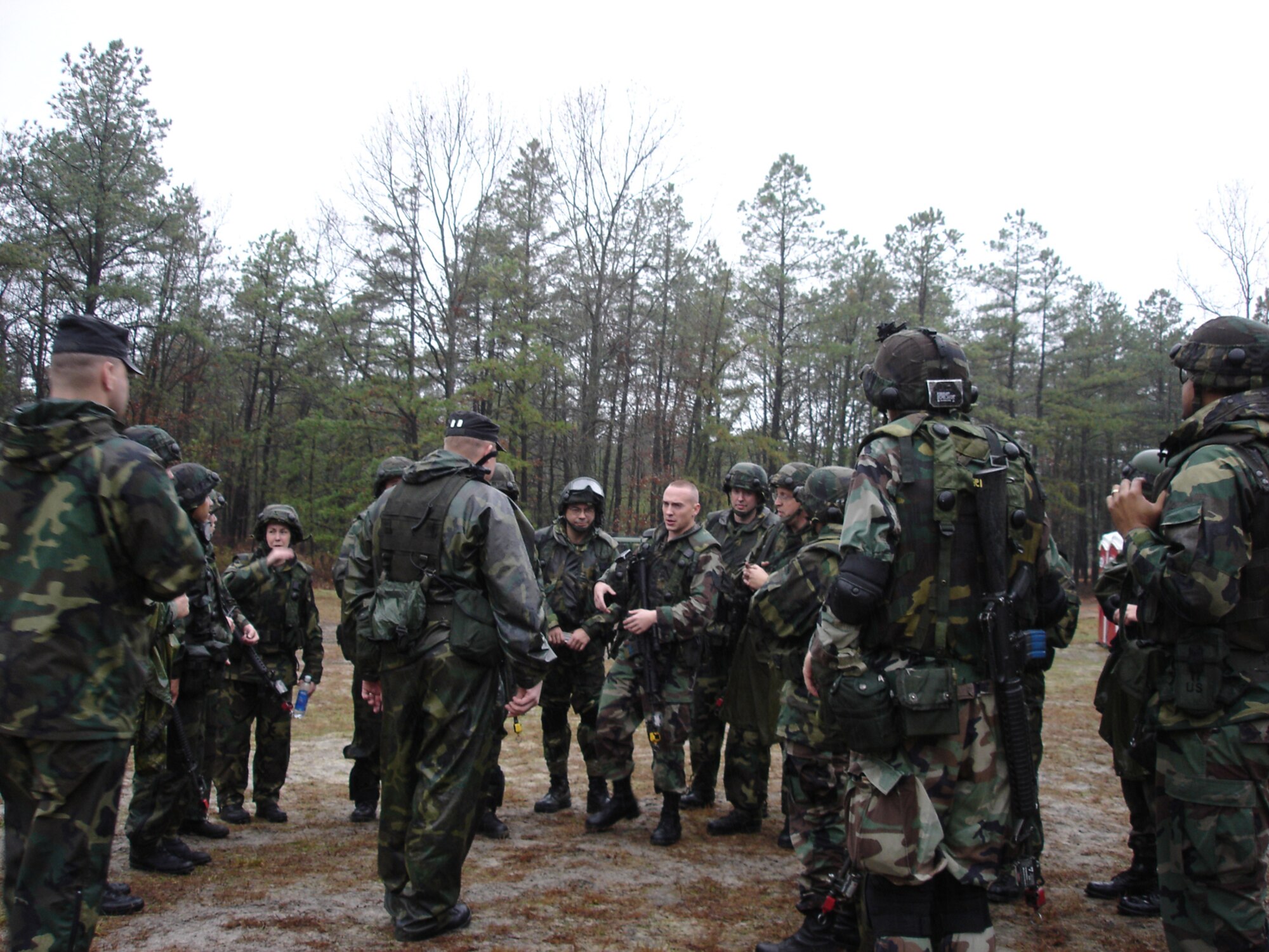 FORT DIX, N.J. -- Air Force students attending Contingency Skills Training discuss a field training exercise they just completed Nov. 14, 2006 with members of the Air Mobility Warfare Center CADRE team.  Each of the students will deploy to locations within the U.S. Central Command Area of Responsibility sometime during the next year.