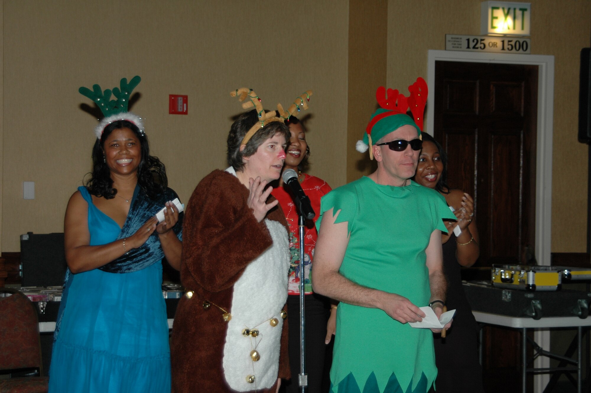More than 460 Airmen here celebrated the season Dec. 1, at the Wing Holiday Party held in the Rushmore Plaza Holiday Inn. The gathering included a performance by the Rapid City Children’s Choir, a slideshow of deployed Ellsworth members, a plated meal, and dancing. Civic leaders attended, as well as Ellsworth civilians, servicemembers of all ranks, and their guests. To decrease the cost of the event, base personnel donated funds to see wing leaders dress in themed attire. Winners of the Santa and elves competition performed for the crowd in costume. 
