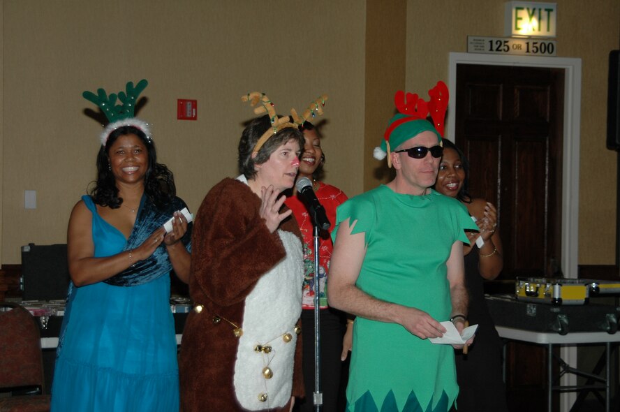 More than 460 Airmen here celebrated the season Dec. 1, at the Wing Holiday Party held in the Rushmore Plaza Holiday Inn. The gathering included a performance by the Rapid City Children’s Choir, a slideshow of deployed Ellsworth members, a plated meal, and dancing. Civic leaders attended, as well as Ellsworth civilians, servicemembers of all ranks, and their guests. To decrease the cost of the event, base personnel donated funds to see wing leaders dress in themed attire. Winners of the Santa and elves competition performed for the crowd in costume. 
(U. S. Air Force photo/2nd Lt. Lauren Wright)