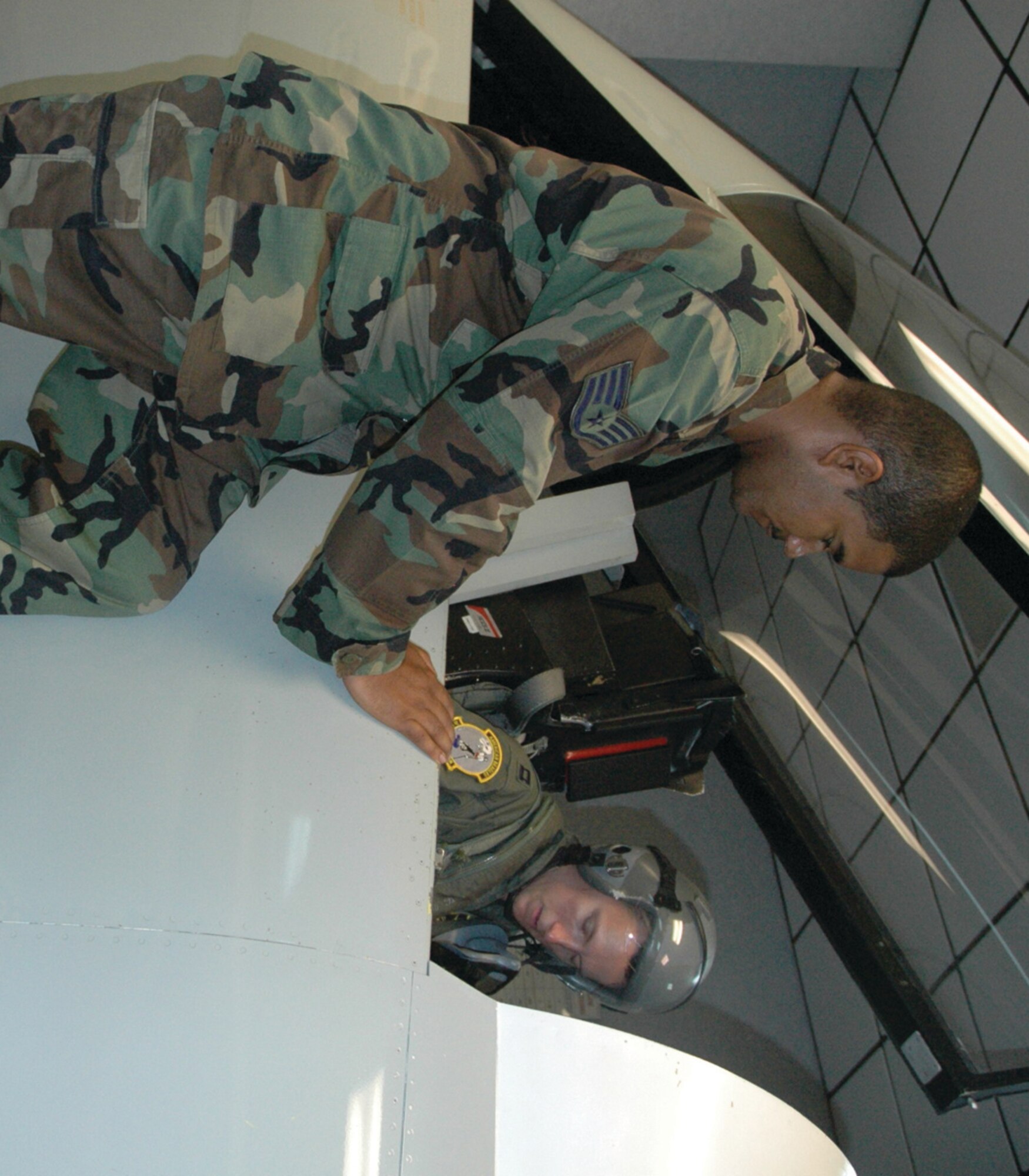 TYNDALL AIR FORCE BASE, Fla. --  Staff Sgt. Jose Rivera, Life Support NCO in charge, helps Capt. Charles Kistler understand F-15 egress procedures. Sergeant Rivera is with the 325th Operations Support Squadron, and Captain Kistler is with the 2nd Fighter Squadron. (U.S. Air Force photo by Chrissy Cuttita)