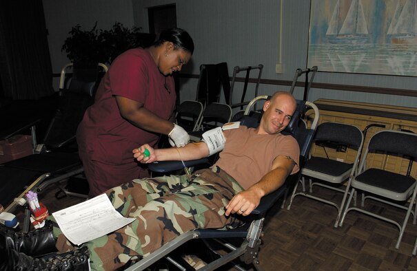 TYNDALL AIR FORCE BASE, Fla. --  Alice Session, Keesler Donor Center staff member, prepares Staff Sgt. Brian Martin, 325th Communication Squadron project manager, for donating blood July 27 at the community center. The Tyndall blood drive collected 121 units of blood. The next blood drive here is scheduled for Oct. 5. (U.S. Air Force photo by Lisa Norman)