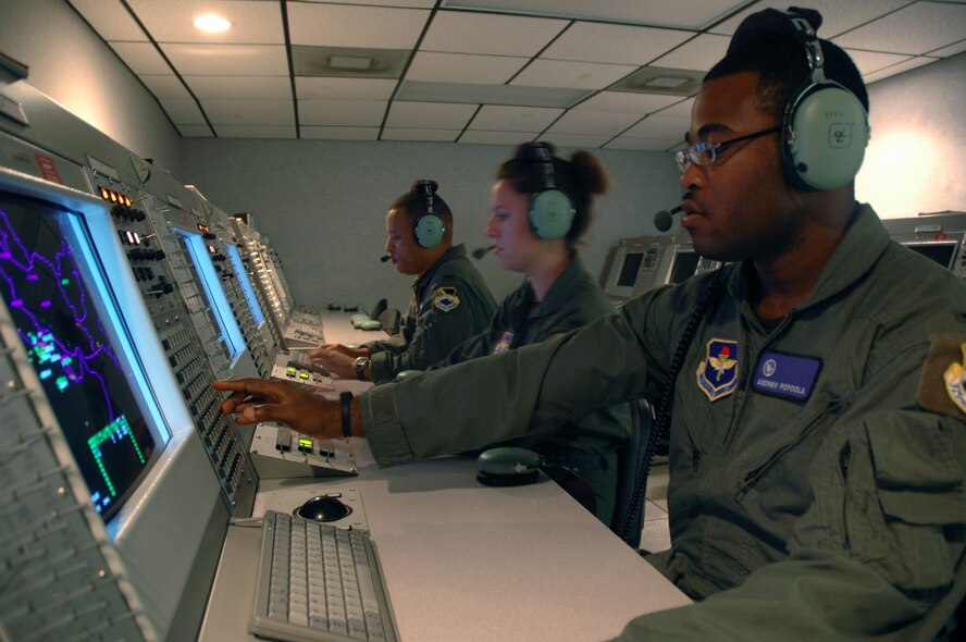 TYNDALL AIR FORCE BASE, Fla. --  First Lts. Andrew Popoola, Renee Powell and Darin Romain, Air Battle Manager students at the 325th Air Control Squadron, practice sending free-text messages to F-22 Raptor pilots. (U.S. Air Force photo by 1st Lt. Jon Quinlan)