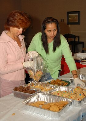 Lorianne Powers, wife of Lt. Col. John Powers, and Gina Lockard, wife of Col. Scott Lockard, sort donated cookies for dorm residents as part of Operation Cookie Drop Wednesday. The operation helps spread holiday cheer by providing Airmen in the dorms with a taste of home for the holidays.
Photo by Airman Vanessa Dale