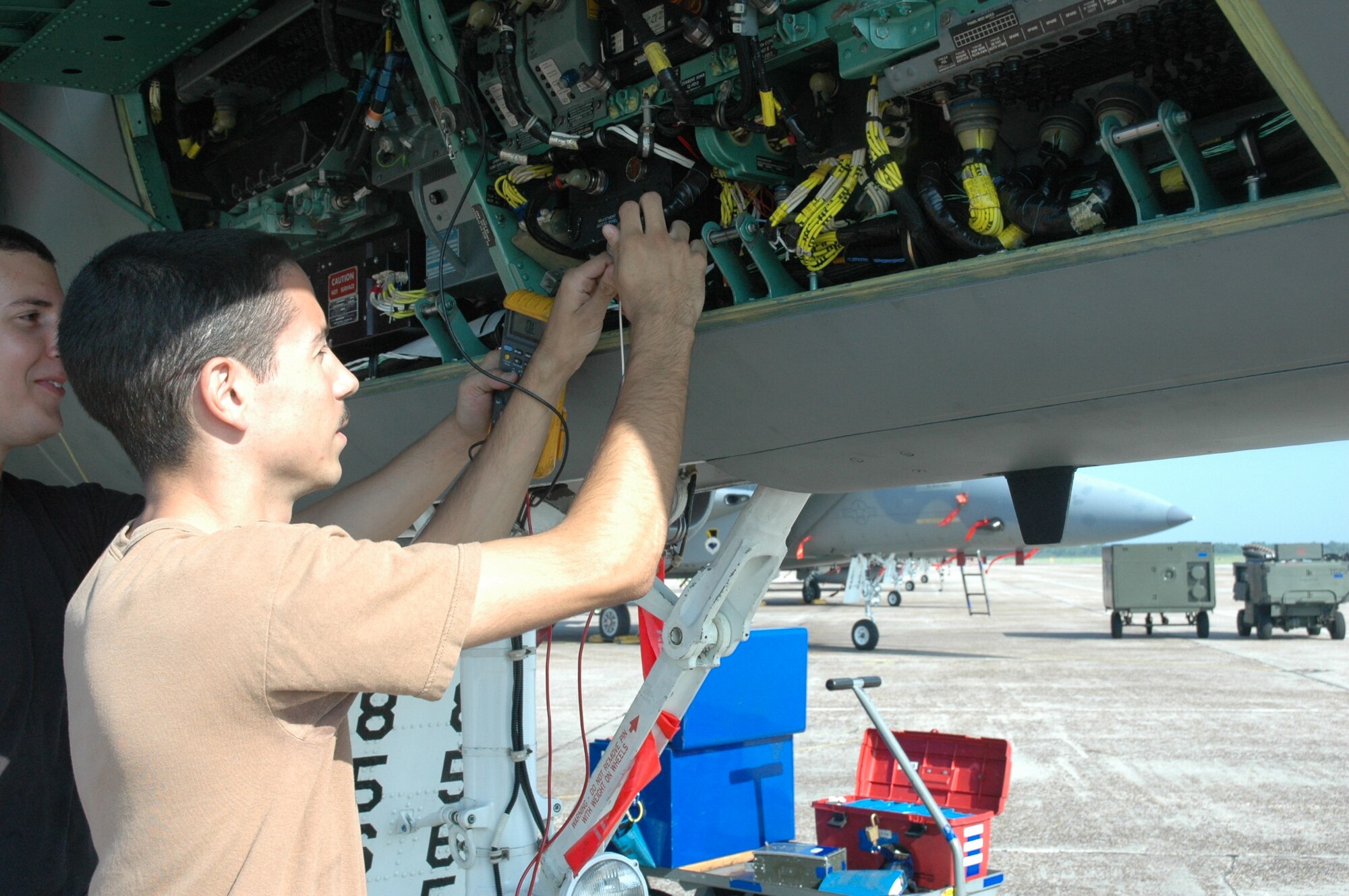 TYNDALL AIR FORCE BASE, Fla. --  Senior Airman Philip Rosa, 95th Aircraft Maintenance Unit avionics technician, troubleshoots F-15 Eagle wires necessary to gauge fuel quantity. Airman Rosa discovered a “flap switch cover” on the ramp, making him the FOD Preventer of the Month for June. (U.S. Air Force photo by Chrissy Cuttita)