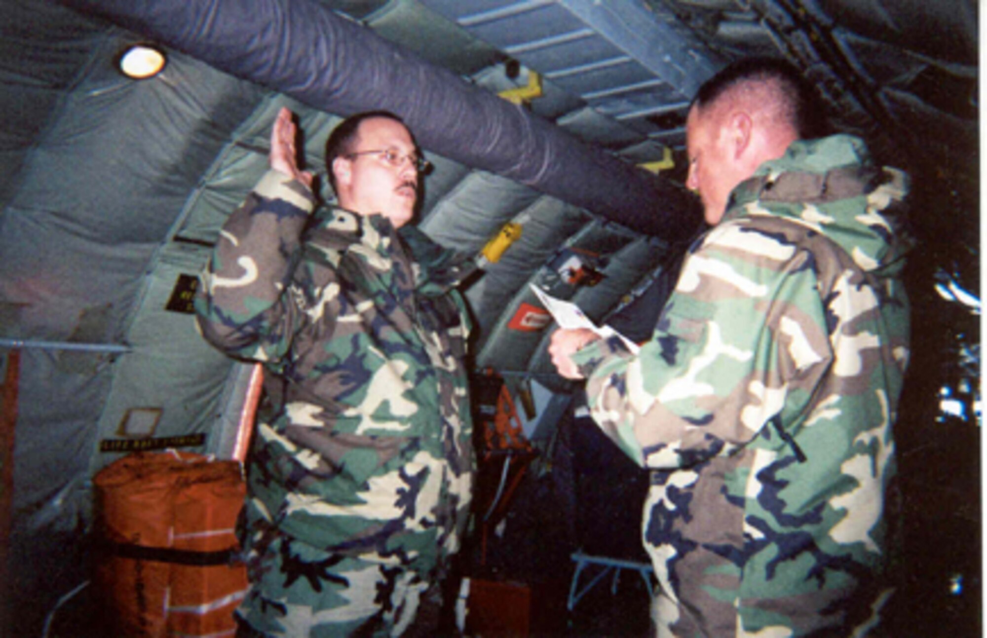 GRISSOM AIR RESERVE BASE, Ind -- Tech. Sgt. Jerome Humprhey, Jr., (left) takes his reenlistment oath aboard a KC-135R Stratotanker during an aerial refueling mission.  The KC-135 was at 27,000 feet over the state of Missouri when the oath was administered by 2nd Lt Chad Summers.  Sergeant Humphrey is a command post controller with the 434th Air Refueling Wing at Grissom ARB.  (U.S. Air Force photo)