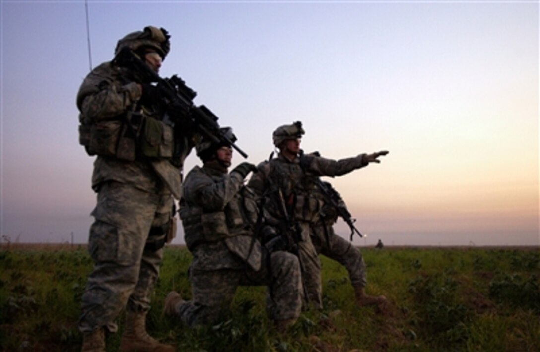 U.S. Army soldiers from Alpha Company, 2nd Battalion, 35th Infantry Regiment, 25th Infantry Division scout Tall Qabb, Iraq, during an operation in search of insurgents and weapons caches on Dec. 8, 2006.  