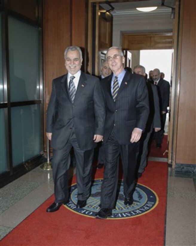 Deputy Secretary of Defense Gordon England (right) escorts Iraqi Vice President Traq Al-Hashimi into the Pentagon for meetings on Dec. 13, 2006.  