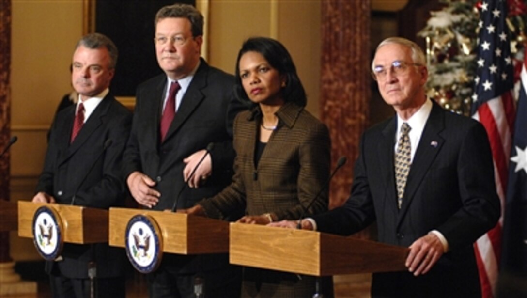 From right, Deputy Defense Secretary Gordon England, Secretary of State Condoleezza Rice, Australian Minister for Foreign Affairs Alexander Downer and Australian Minister for Defense Brendan Nelson listen to a reporter's question during a media availability at the State Department's Franklin Room in Washington, D.C., Dec. 12, 2006, during U.S.-Australian bilateral ministerial meetings.
