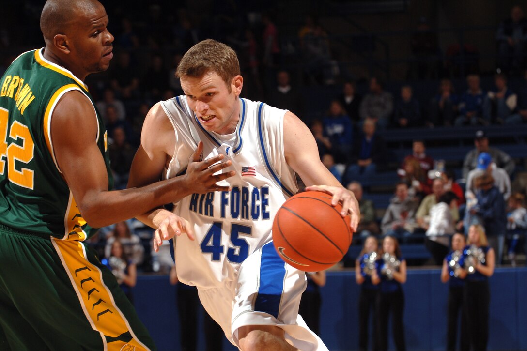 Falcon center Nick Welch drives past Norfolk State's Calvin Brown Dec. 13 at Clune Arena. Welch scored eight points and grabbed five rebounds in Air Force's 70-47 win over the Spartans. (U.S. Air Force photo/Dave Armer)