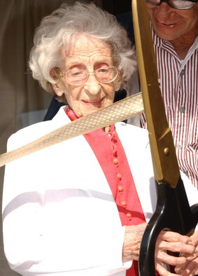 Hortense “Tonsie” Gaudé, 103, of Biloxi cuts the reopening ribbon Monday at Gaudé Lanes which is named after her late son, 1st Lt. Robert Gaudé. The facilty has been closed for repairs since May. (U.S. Air Force photo by Kemberly Groue)