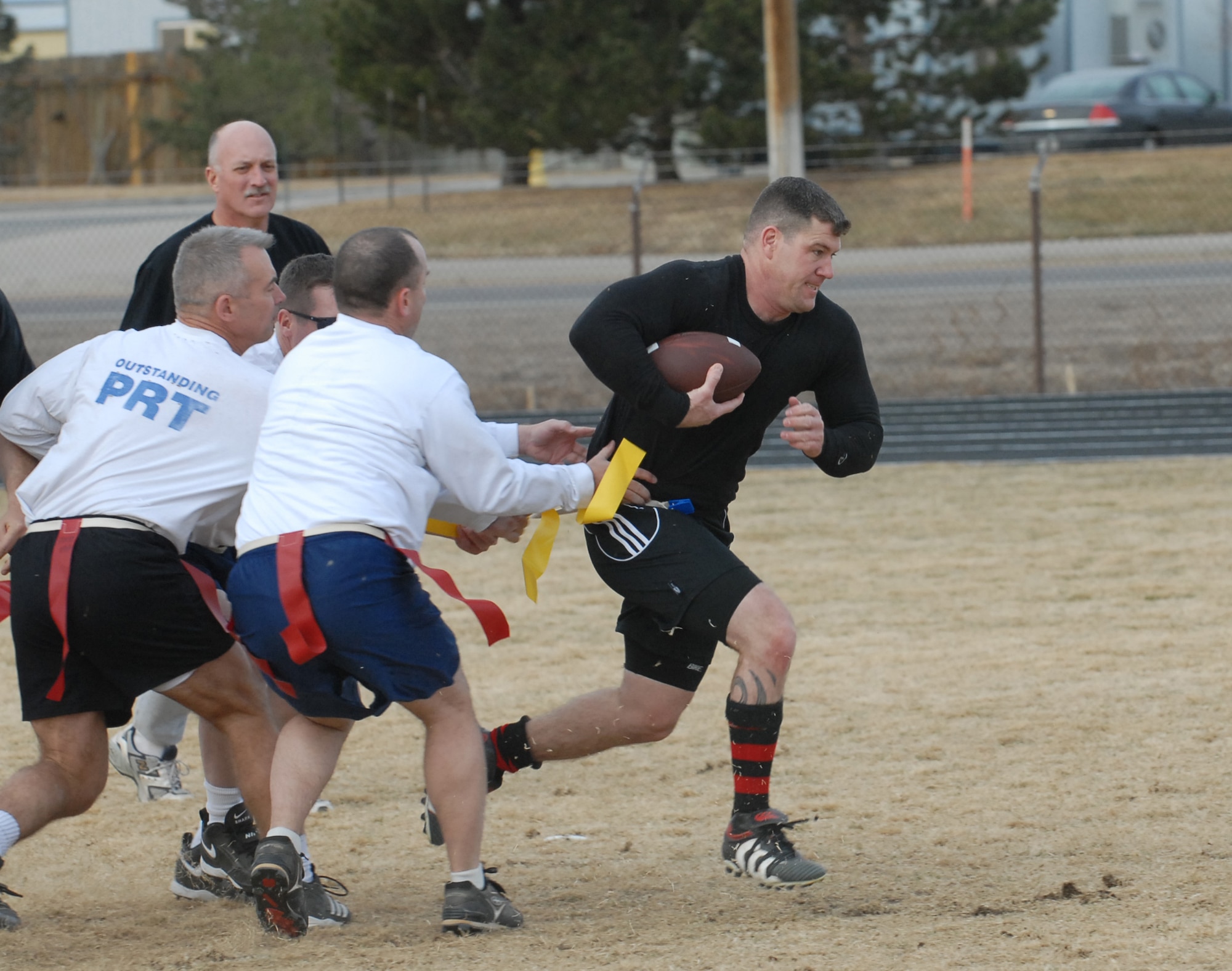 Jeff Beckford, Eagles/Commanders team member, breaks through the Chiefs/Shirts defense in a flag football game Dec. 14. The Chiefs slaughtered the Eagles, 31-0. (U.S. Air Force photo by Airman 1st Class Alex Gochnour)