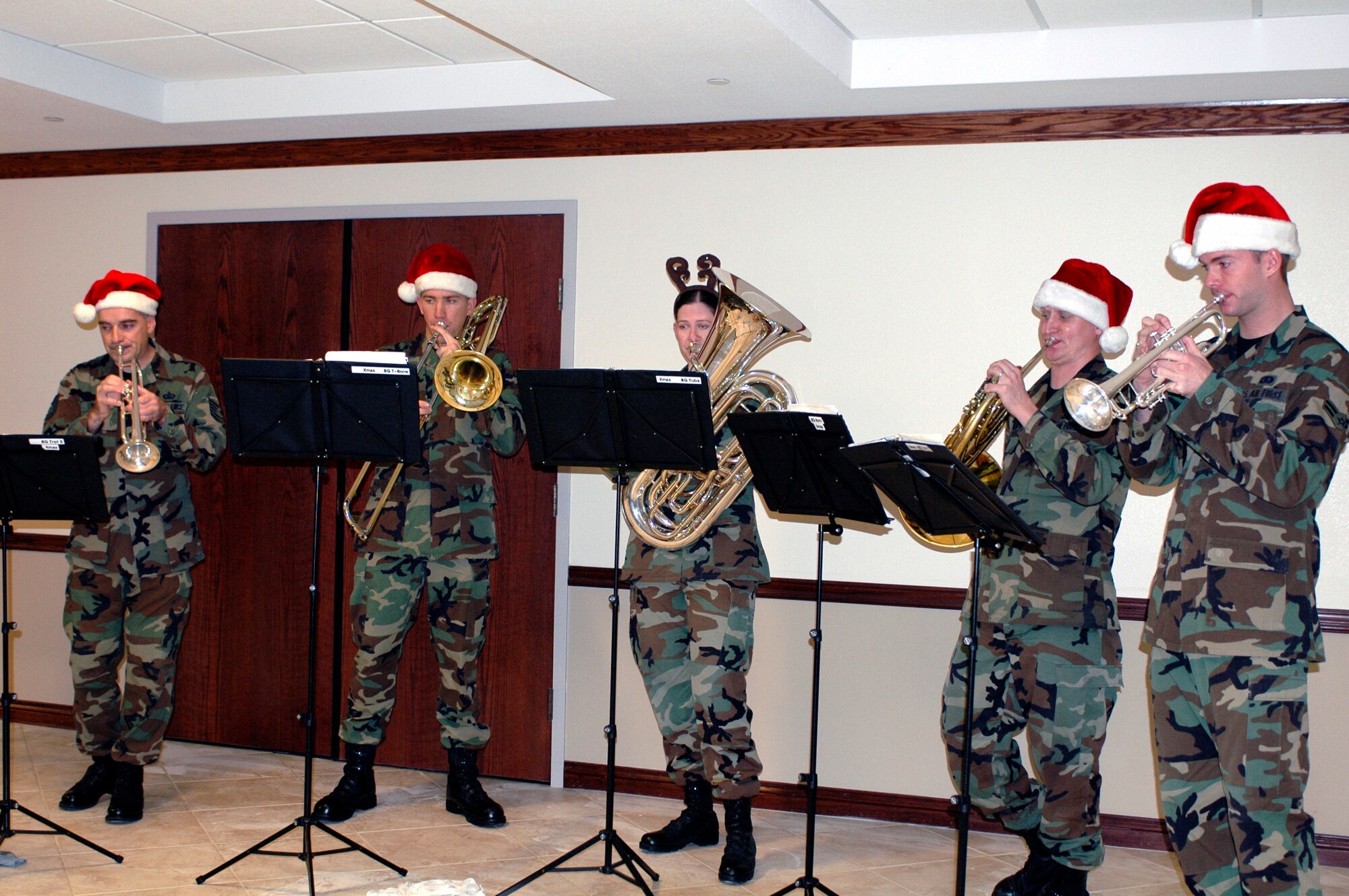 Members of the USAF Band of the Golden West's Brass Quintet perform for the 60th Air Mobility Wing members Dec. 13. (From left to right), Tech. Sgt. Brian Wood, Airman 1st Class Ryan Williams, Senior Airman Jill Corbett, Senior Airman Edwin Ochsner and Airman 1st Class James Lantz visited different units at Travis to spread some holiday cheer. Team Travis members were invited to sing carols as the band played. (U.S. Air Force photo by Staff Sgt. Candy Knight)
