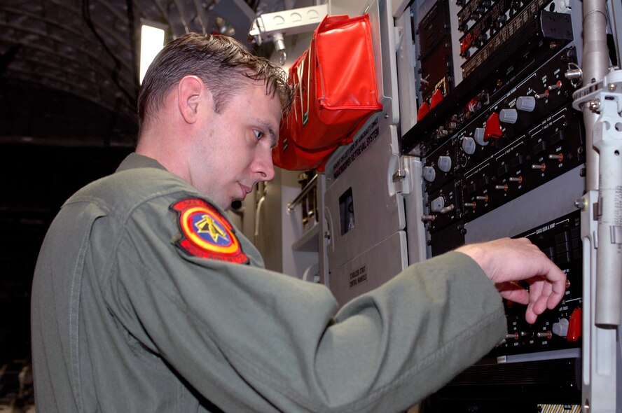 Tech. Sgt, Corey Clewley, 21st Airlift Squadron loadmaster, checks equipment on a C-17 prior to takeoff. While performing a special mission in Southwest Asia, he helped suppress a brake fire onboard a Romanian C-130, saving the lives of the C-130 crew and preventing the total loss of the aircraft.