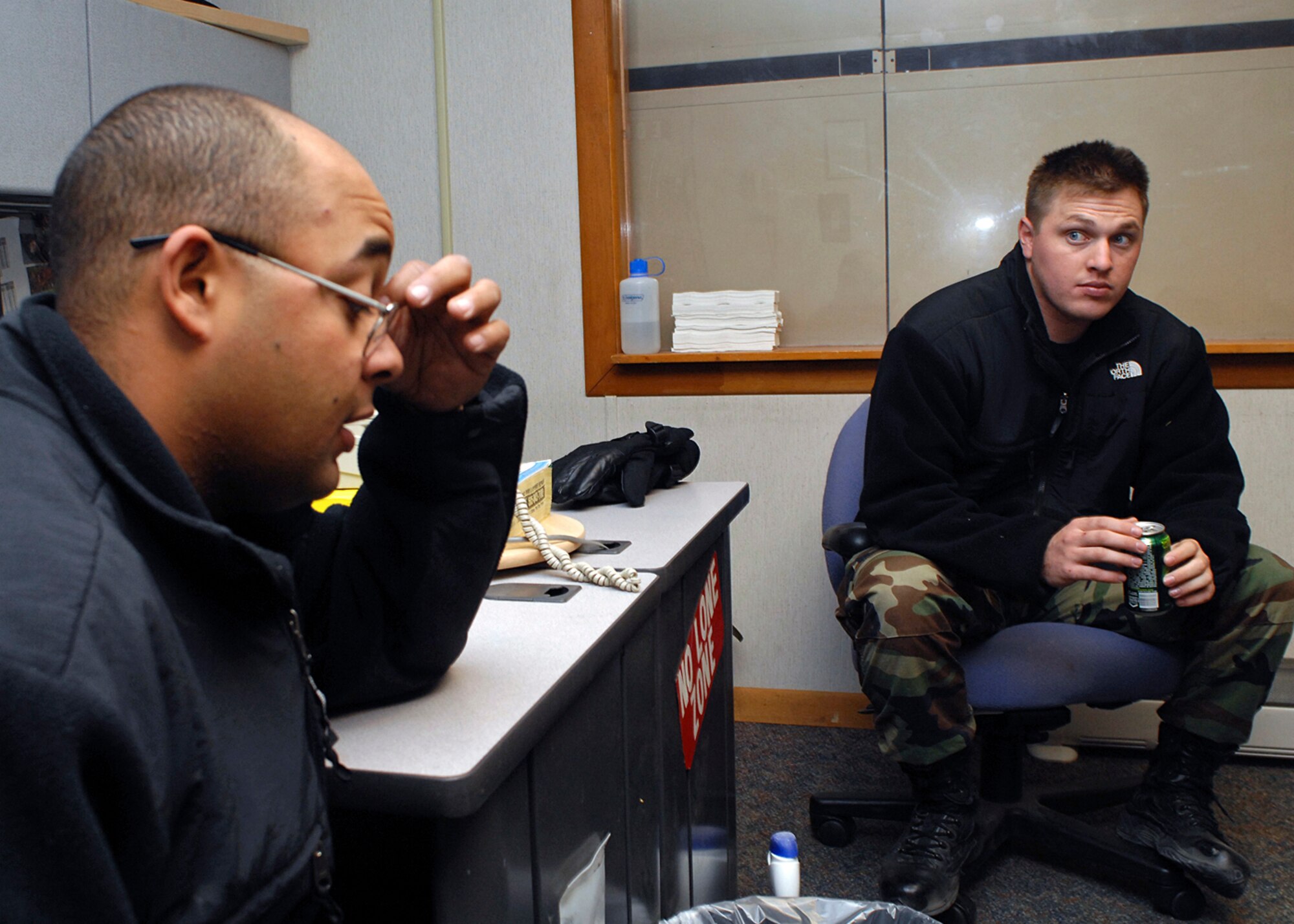 KIRTLAND AIR FORCE BASE, N.M. -- Senior Airman William Zow (foreground) and Senior Airman Nick Worthington (background) discuss their experiences while they were deployed in support of Operation Iraqi Freedom. (U.S. Air Force photo by Todd Berenger)