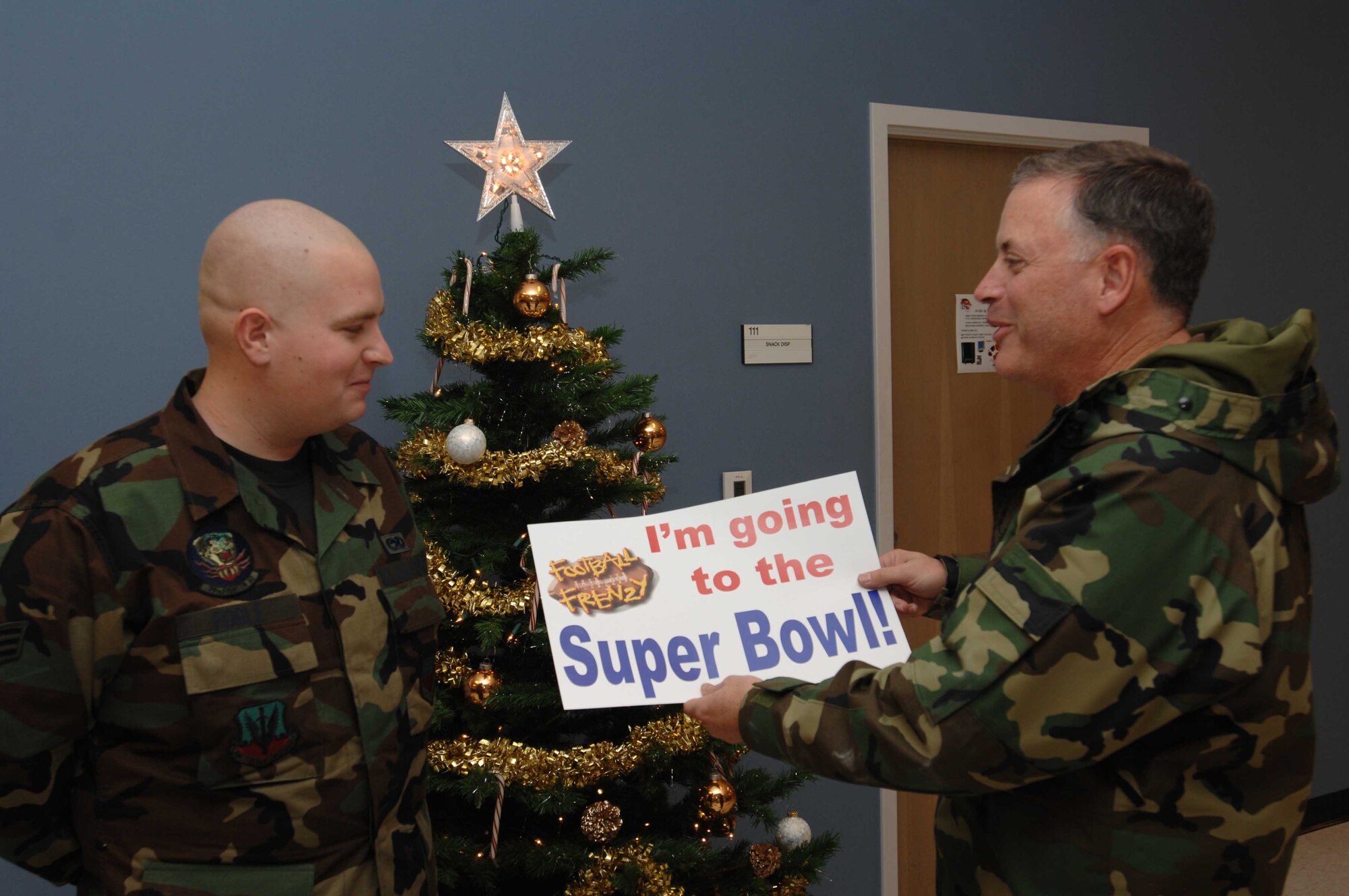 SHAW AIR FORCE BASE, S.C.-- Col. Michael Vidal (right), 20th Maintenance Group commander, tells Senior Airman Christian Fogle, 20th Aircraft Maintenance Squadron, he won two tickets to Super Bowl XLI in Miami. Airman Fogle was told Dec. 8 that he had won the Air Force Services Football Frenzy Super Bowl XLI trip. He is one of four winners Air Force-wide. In addition to the tickets, each winner will receive round-trip airfare and hotel accommodations for two, a rental car and tickets to Miami attractions. (U.S. Air Force photo/Air 1st Class William Coleman)