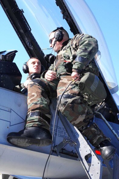 SHAW AIR FORCE BASE, S.C. -- Staff Sgt. Brian Gaylor (left) helps Senior Airman James Ferrell, both of the 77th Fighter Squadron, repair a simulated downed F-16 Fighting Falcon during the operational readiness exercise Dec. 5. (U.S. Air Force photo/Senior Airman Matthew Davis)