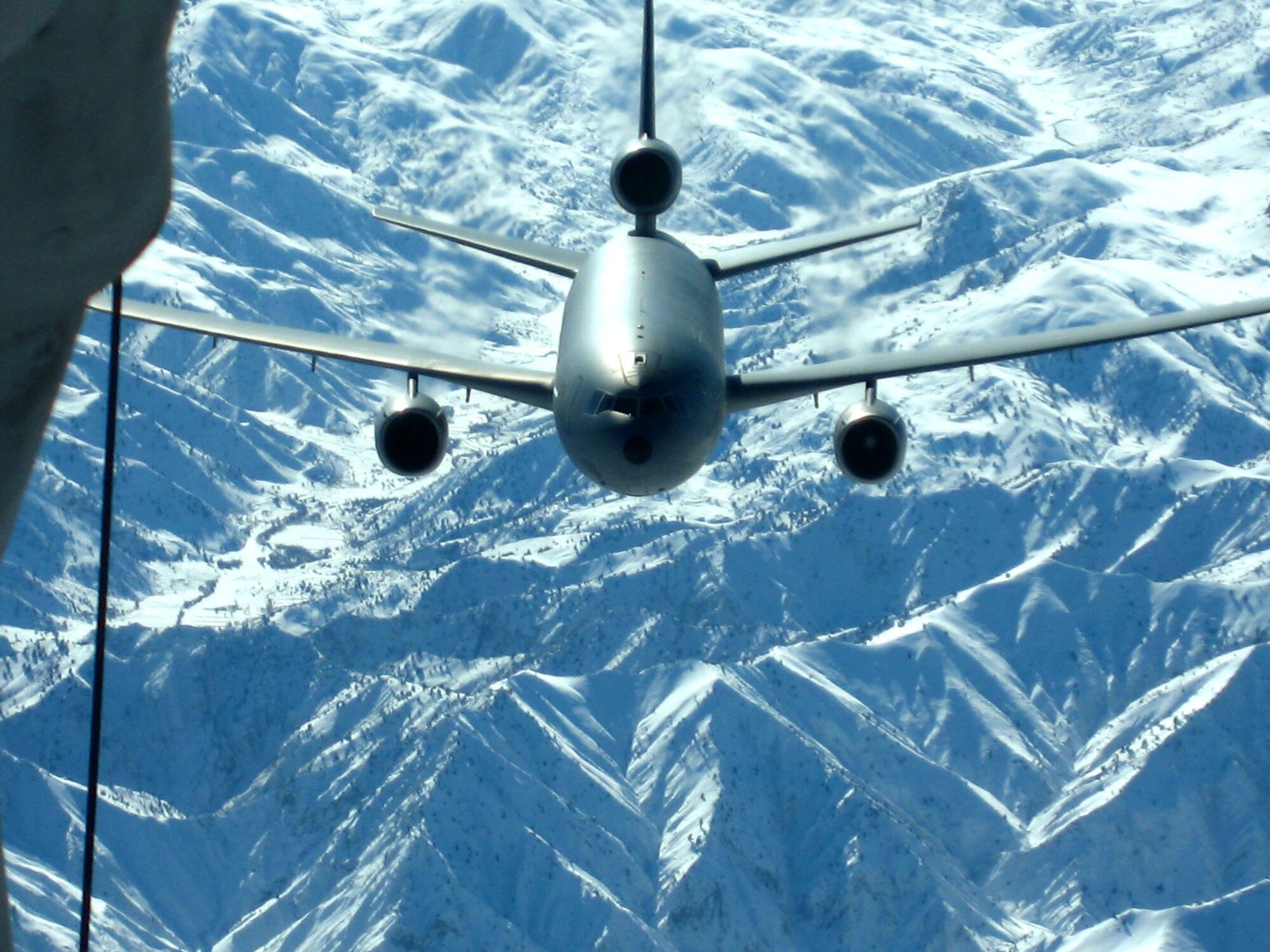 A KC-10 Extender from the 380th Air Expeditionary Wing in Southwest Asia pulls up behind another KC-10 from the wing Dec. 14 over Afghanistan. Both refuelers were supporting Operation Enduring Freedom missions being flown by U.S. and coalition aircraft.  The 380th AEW is home to the largest air refueling wing in Southwest Asia, flying KC-10s and KC-135 Stratotankers in support of wartime operations. (U.S. Air Force photo/Capt. Justin T. Watson)