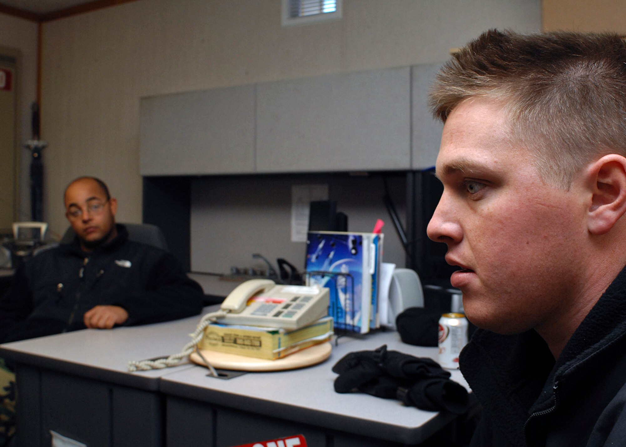 KIRTLAND AIR FORCE BASE, N.M. -- Senior Airman Nick Worthington (foreground) and Senior Airman William Zow (background) discuss their experiences while they were deployed in support of Operation Iraqi Freedom. (U.S. Air Force photo by Todd Berenger)