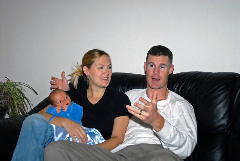 KIRTLAND AIR FORCE BASE, N.M. -- Staff Sgt. Jarod Savage, a survival, evasaion, resistance, and escape instructor with the 342nd Training Squadron, Detachment 1, here, talks with his wife Linda and newborn son Micah about the day his son was born. Sergeant Savage delivered Micah at his on base home minutes before the fire department arrived. (U.S. Air Force photo by Laurence Zankowski)