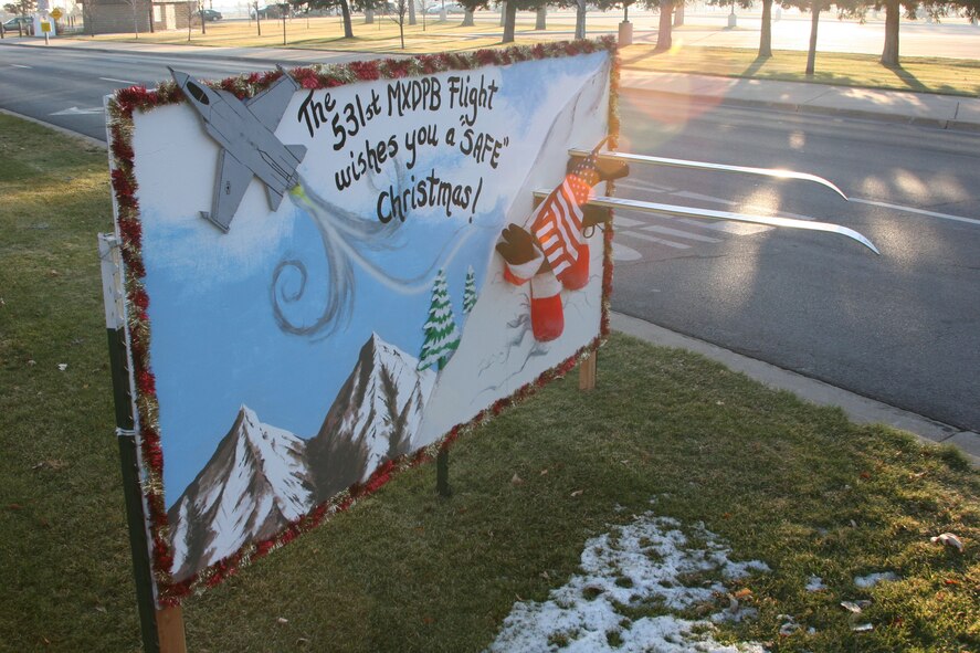 Lined up near the south gate, greeting cards like this one from the 531st Commodities Maintenance Squadron Pneudralics Flight make drivers feel welcome as they come and leave the base.