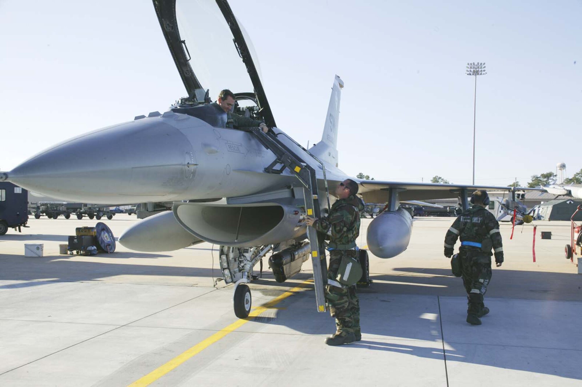 SHAW AIR FORCE BASE, S.C. -- Senior Airman Russell Reynolds, 55th Aircraft Maintenance Unit crew chief, places a ladder on the jet for Capt. Michael Steele, 55th Fighter Squadron pilot, following a sortie Dec. 5 during the operational readiness exercise. (U.S. Air Force photo/Senior Airman Holly MacDonald)